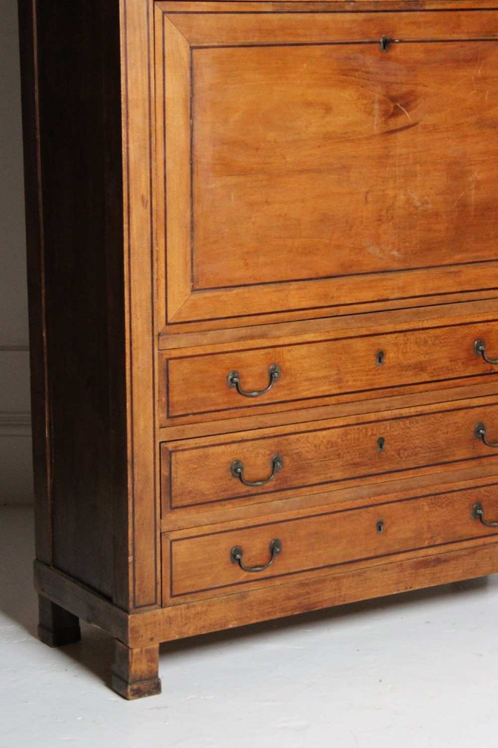 A tall 19th-century fruitwood secretaire cabinet featuring a glazed double-door upper section, a fall-front writing flap, and three long drawers below. View VII