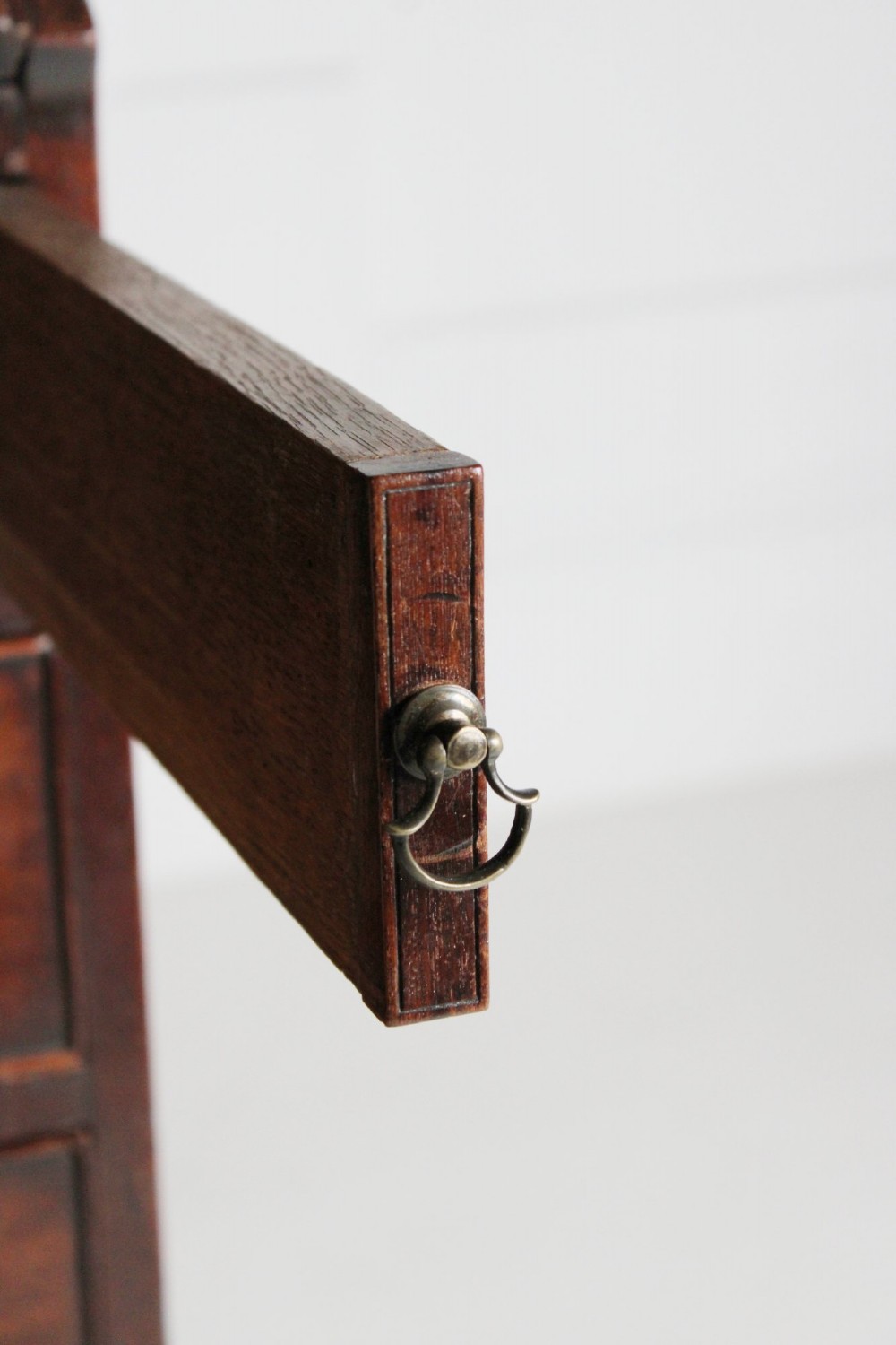 A George III mahogany fall front bureau featuring four graduated drawers with brass handles, resting on bracket feet. View III