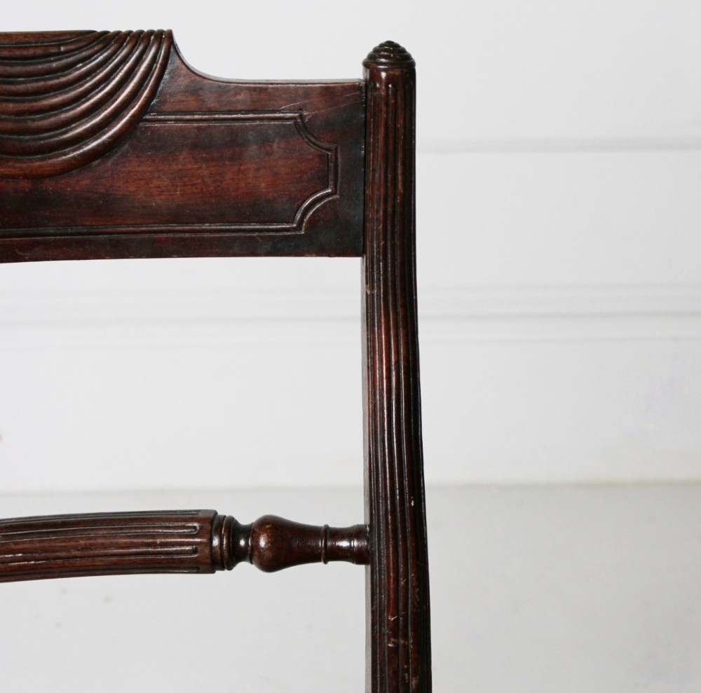 A Regency mahogany side chair with carved sabre legs, reeded frame, and olive green velvet upholstered seat with braid trim. View III