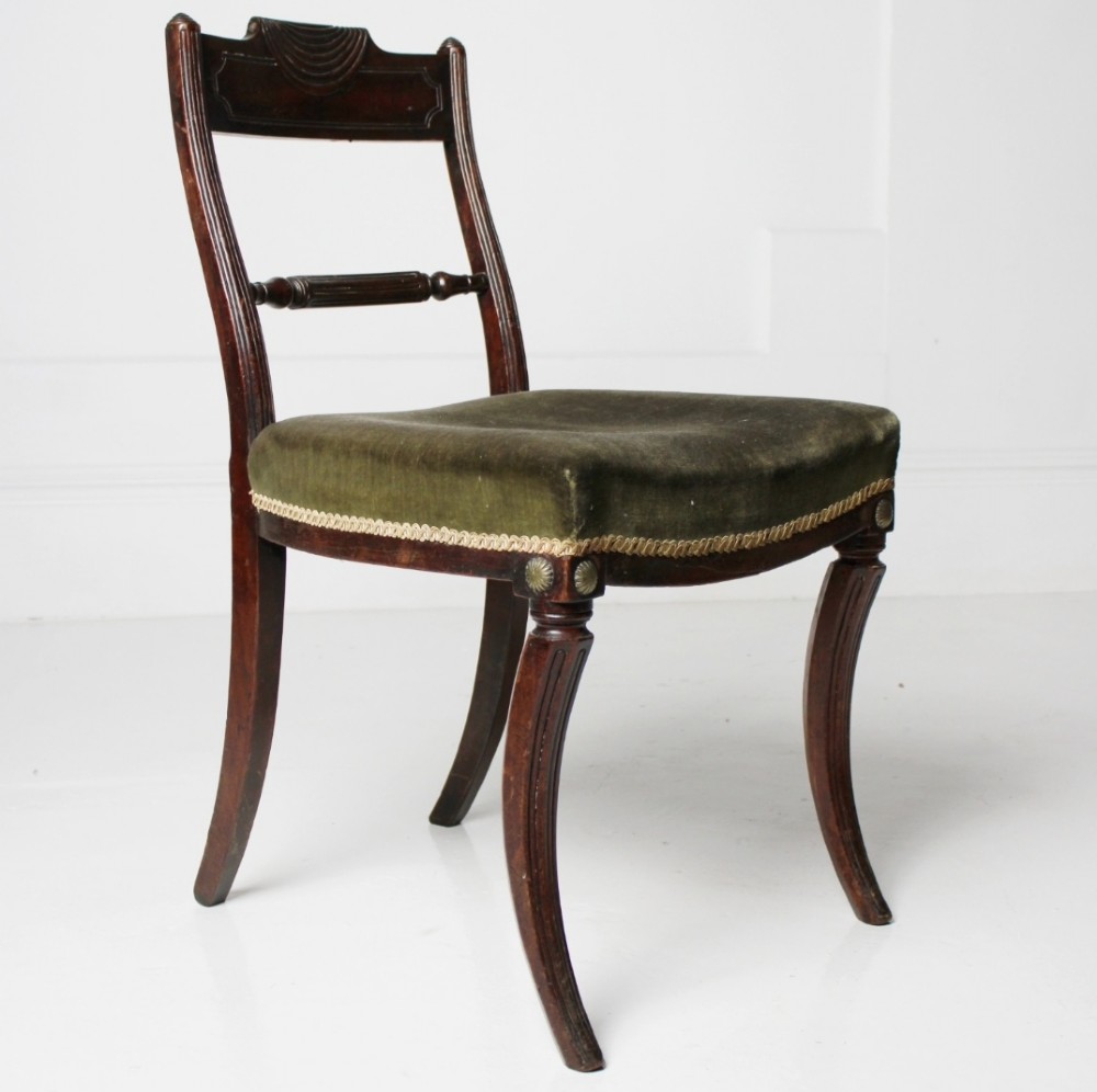 A Regency mahogany side chair with carved sabre legs, reeded frame, and olive green velvet upholstered seat with braid trim. View IV