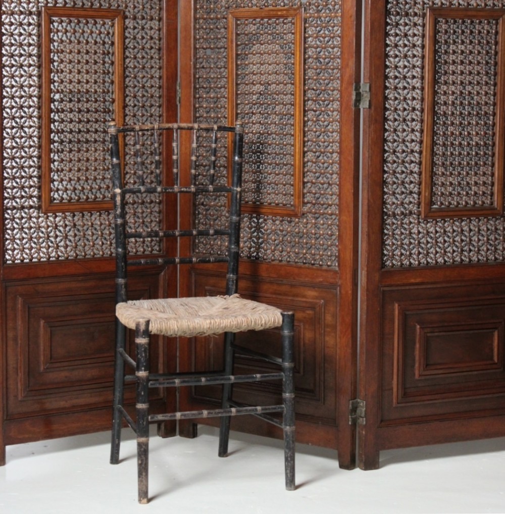 A four-panel dark hardwood folding screen featuring intricate geometric mashrabiya latticework panels above carved recessed bottom sections. View II