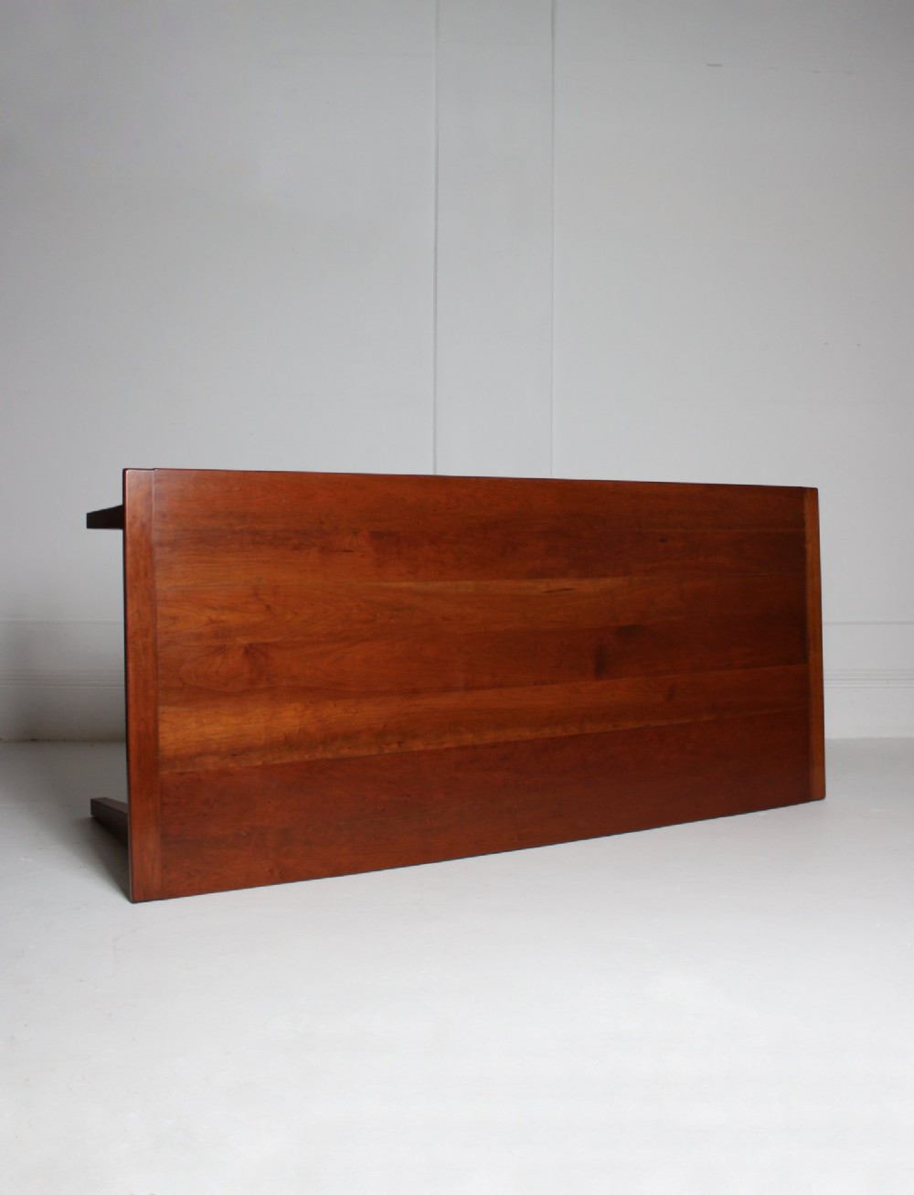 A rectangular French cherrywood dining table featuring tapered legs, a plain apron, and an end drawer with a dark circular pull knob. View VIII