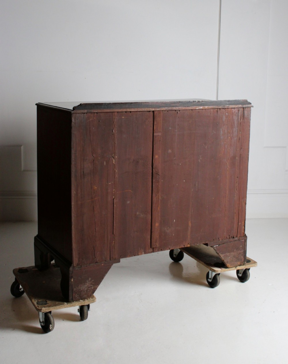 A George III mahogany chest of drawers featuring three graduated long drawers with brass swan-neck handles and bracket feet. View IX