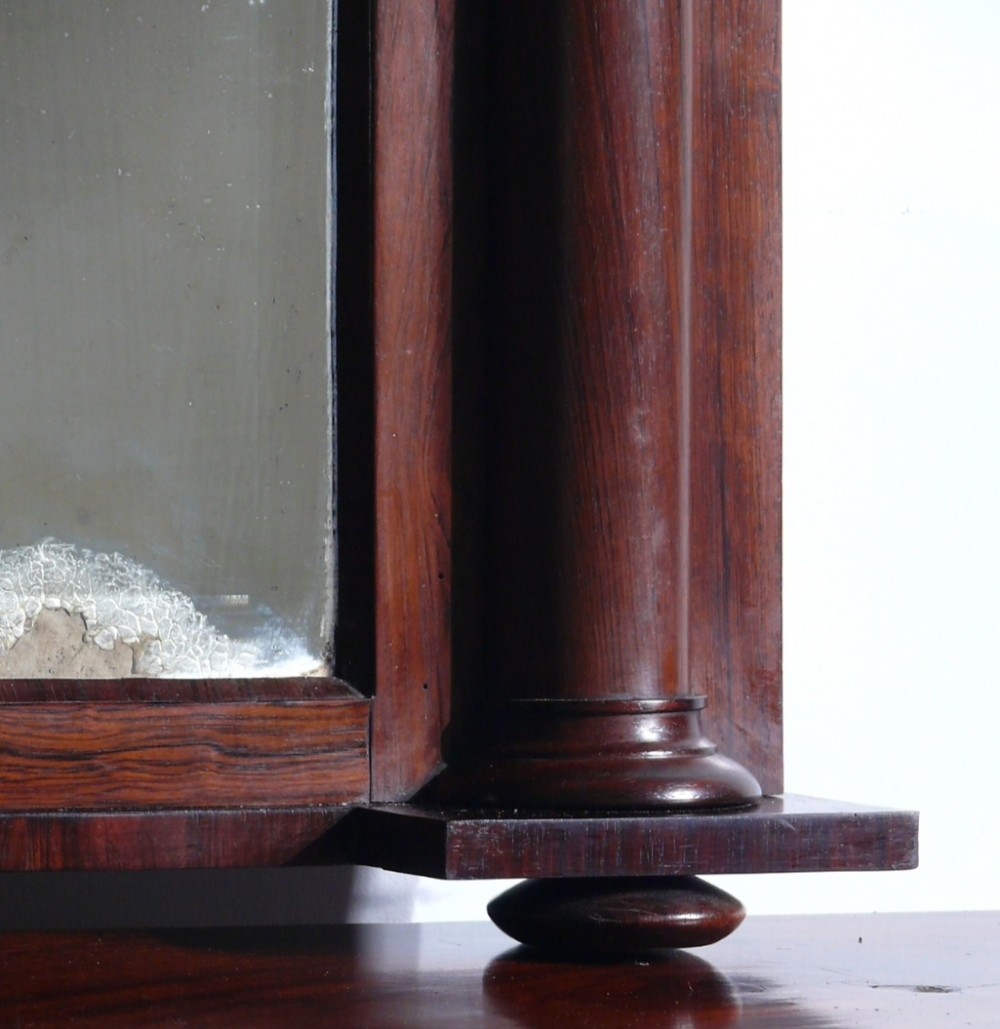 A 19th-century rosewood overmantel mirror featuring a pediment top and turned side columns with carved roundel capitals. View V