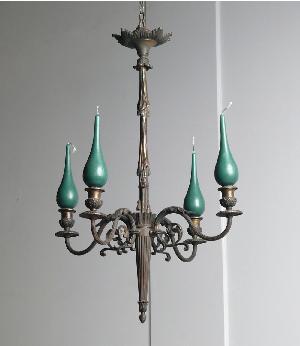A 19th-century French dark bronze four-arm candle chandelier with scrolling branches, leaf motifs, and a central fluted column.