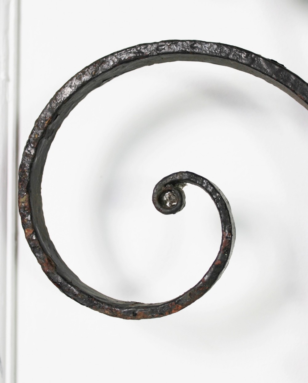 A tall Victorian Gothic Revival iron arch with a pointed apex, decorative crockets along the outer edges, and circular tracery within the upper pediment. View VI