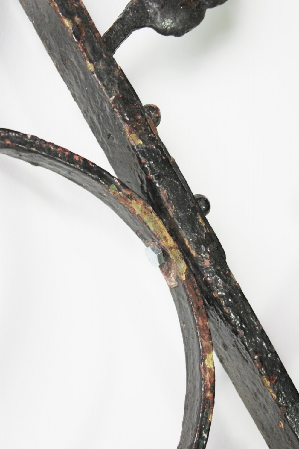 A tall Victorian Gothic Revival iron arch with a pointed apex, decorative crockets along the outer edges, and circular tracery within the upper pediment. View IX