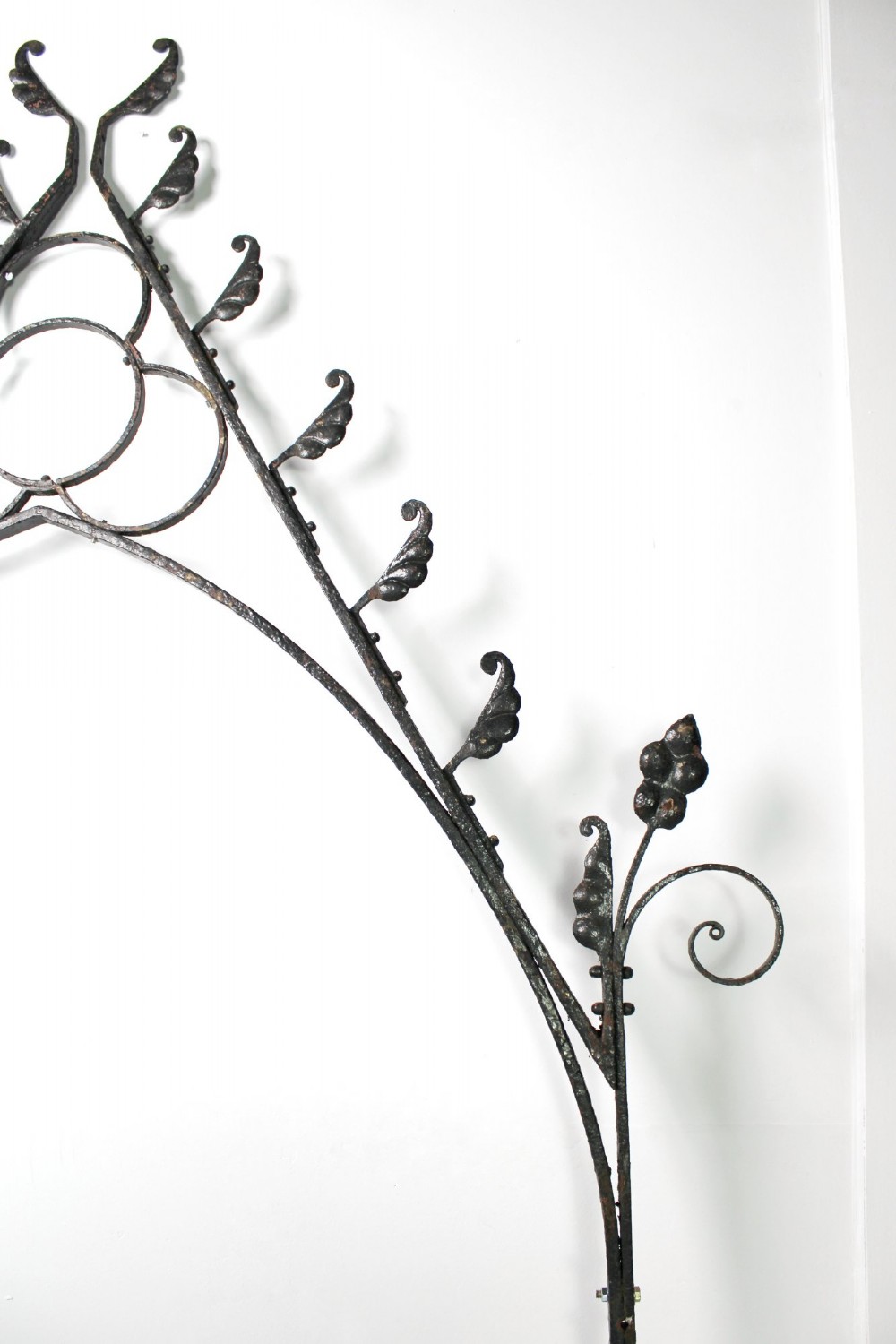 A tall Victorian Gothic Revival iron arch with a pointed apex, decorative crockets along the outer edges, and circular tracery within the upper pediment. View XI