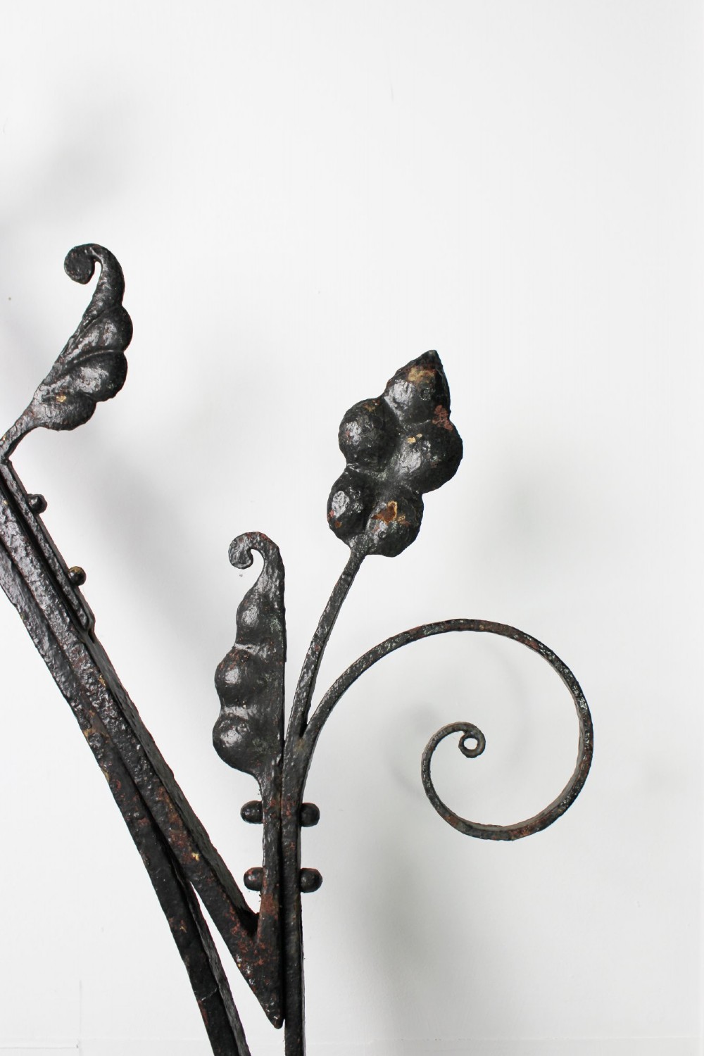 A tall Victorian Gothic Revival iron arch with a pointed apex, decorative crockets along the outer edges, and circular tracery within the upper pediment. View XII