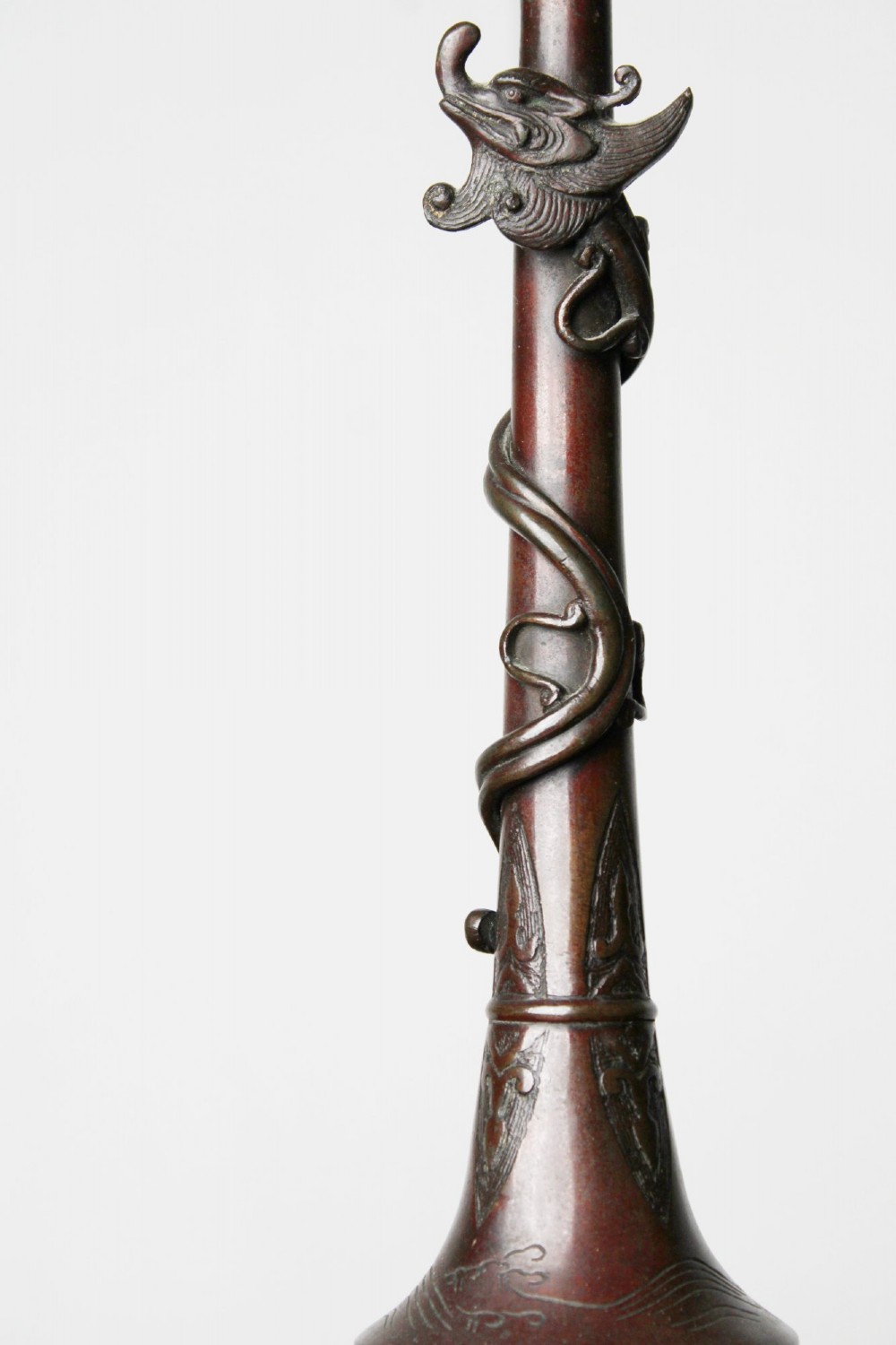 An antique dark bronze table lamp base featuring a sculpted dragon wrapped around a slender stem above a rounded base. View III
