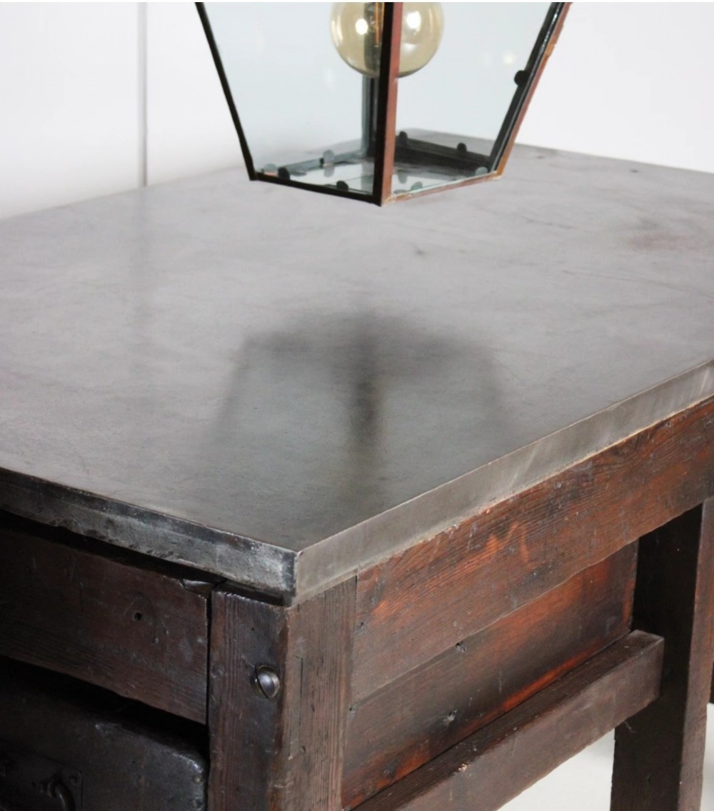 A heavy Victorian dark wood industrial typesetting table featuring a flat metal surface, deep storage drawers, and robust square legs. View II