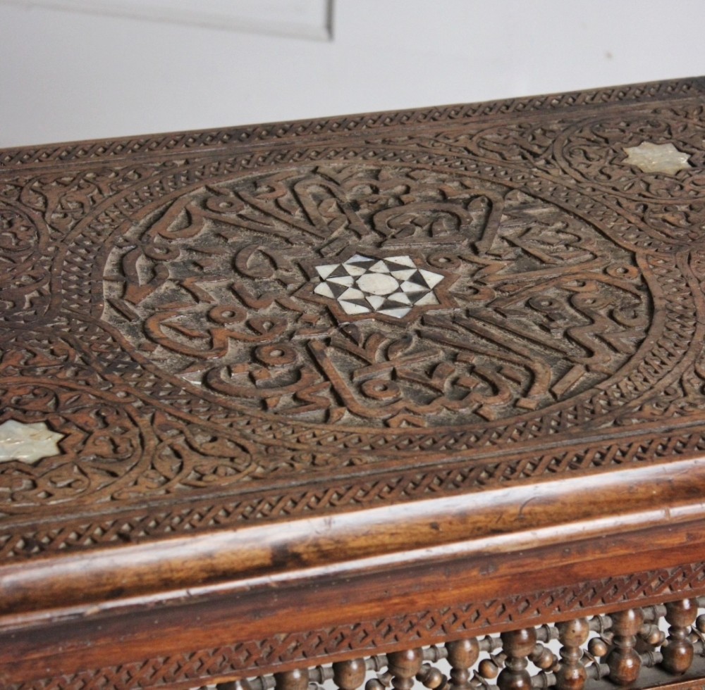 A 19th-century two-tier Syrian side table made from dark walnut with geometric mother-of-pearl inlay and carved openwork lattice panels. View II