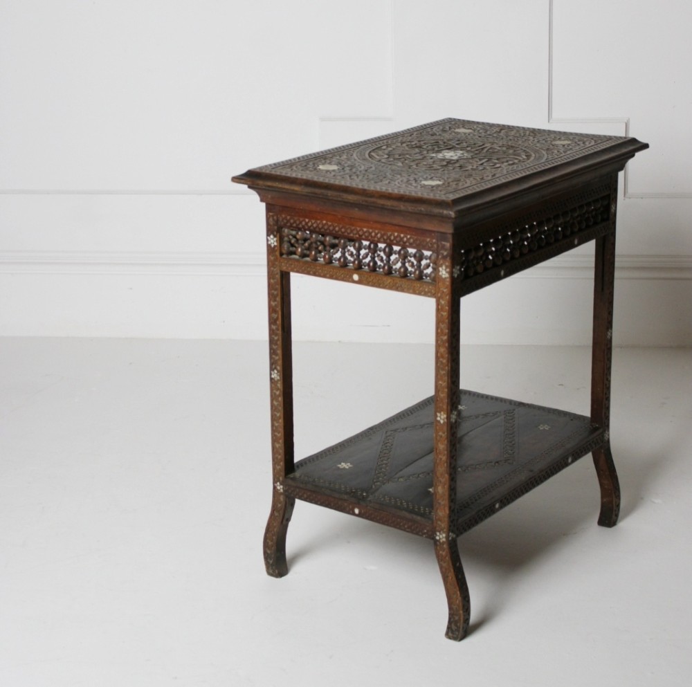 A 19th-century two-tier Syrian side table made from dark walnut with geometric mother-of-pearl inlay and carved openwork lattice panels. View III