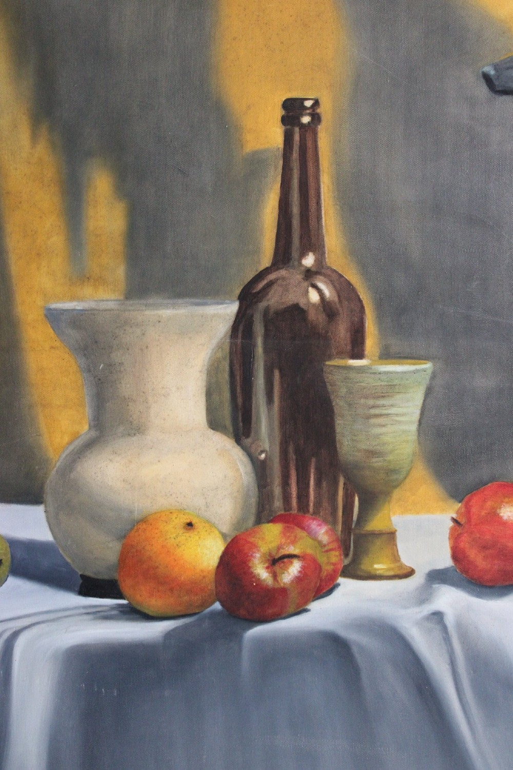 A large mid-20th-century oil painting depicting a draped tabletop still life with fruit, ceramic vessels, and a dark greyhound sculpture against a yellow and grey backdrop. View III