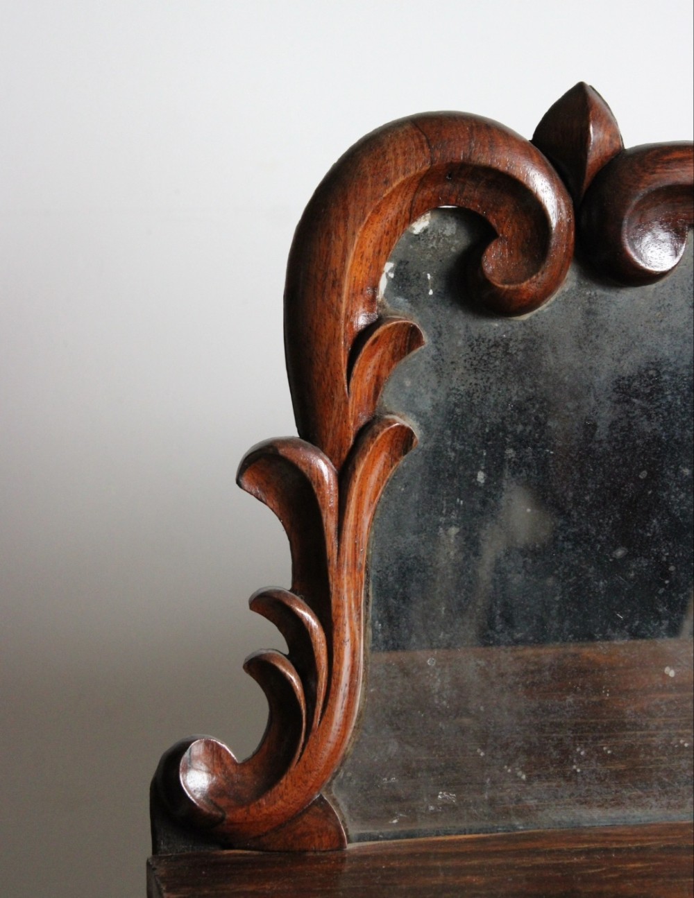 A Regency rosewood chiffonier featuring a carved crest above a distressed mirror back and two lower doors with pleated green fabric panels. View III