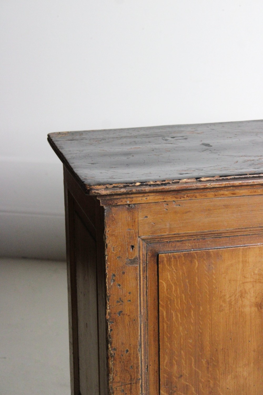 A Victorian painted pine shop counter featuring a scumbled faux oak finish, two large recessed front panels, and a low plinth base. View IV