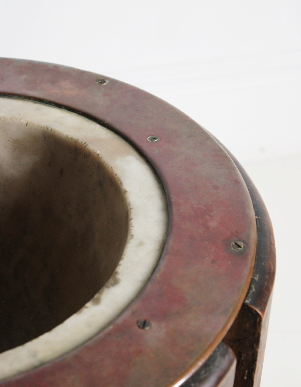 A late 19th-century floor-standing wooden mortar constructed from a hollowed trunk section with an inset stone basin and a pestle. View V