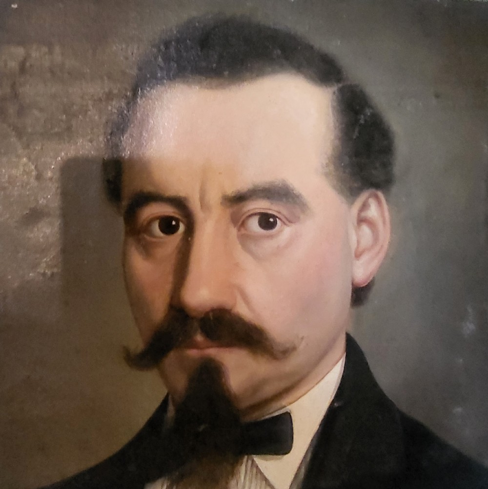 An antique oil painting on canvas depicting a gentleman with a moustache holding a feather quill pen over a book. View IV