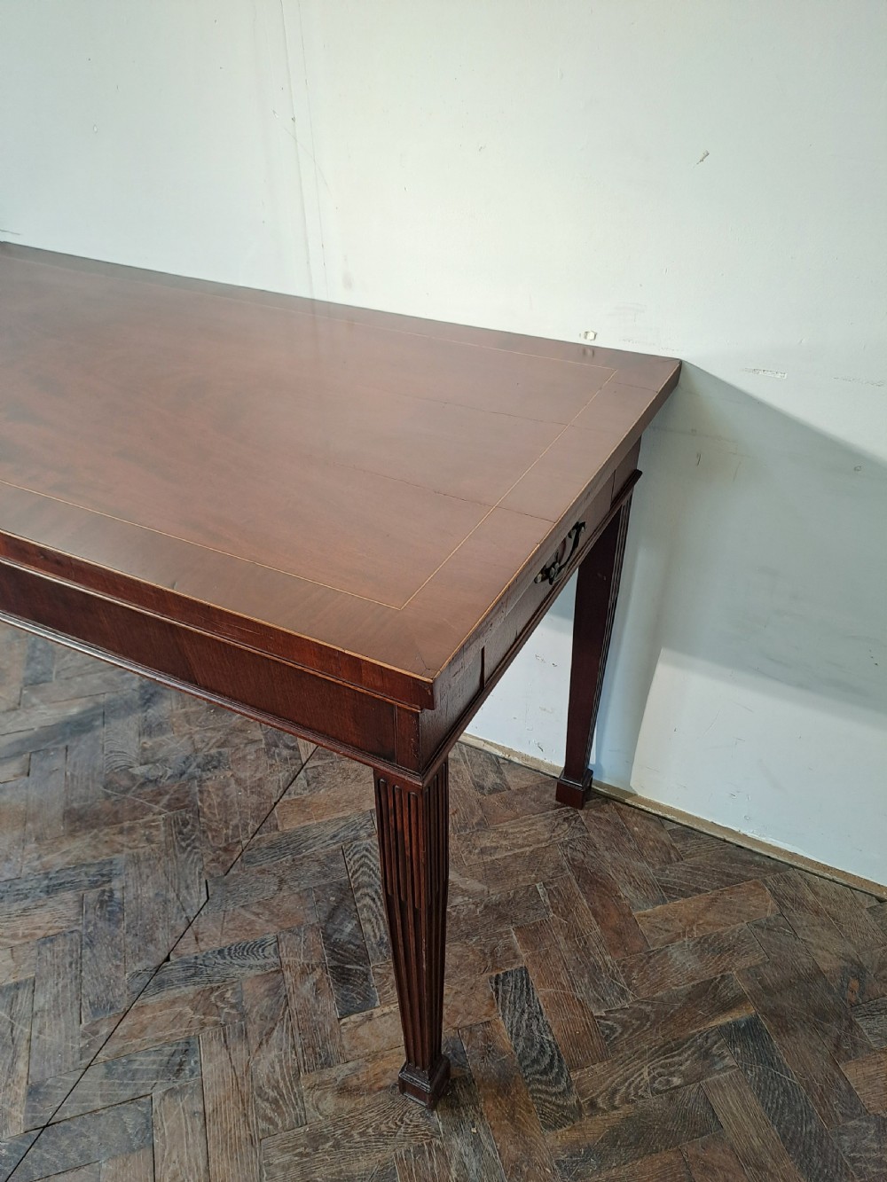 A Georgian dark mahogany rectangular console table featuring fluted square tapered legs and subtle top line inlay. View III