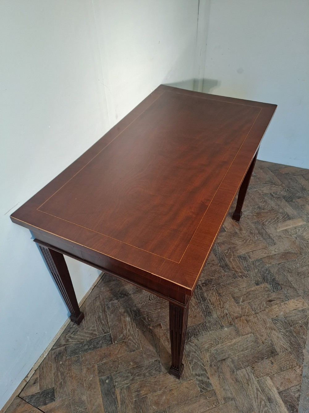 A Georgian dark mahogany rectangular console table featuring fluted square tapered legs and subtle top line inlay. View IV