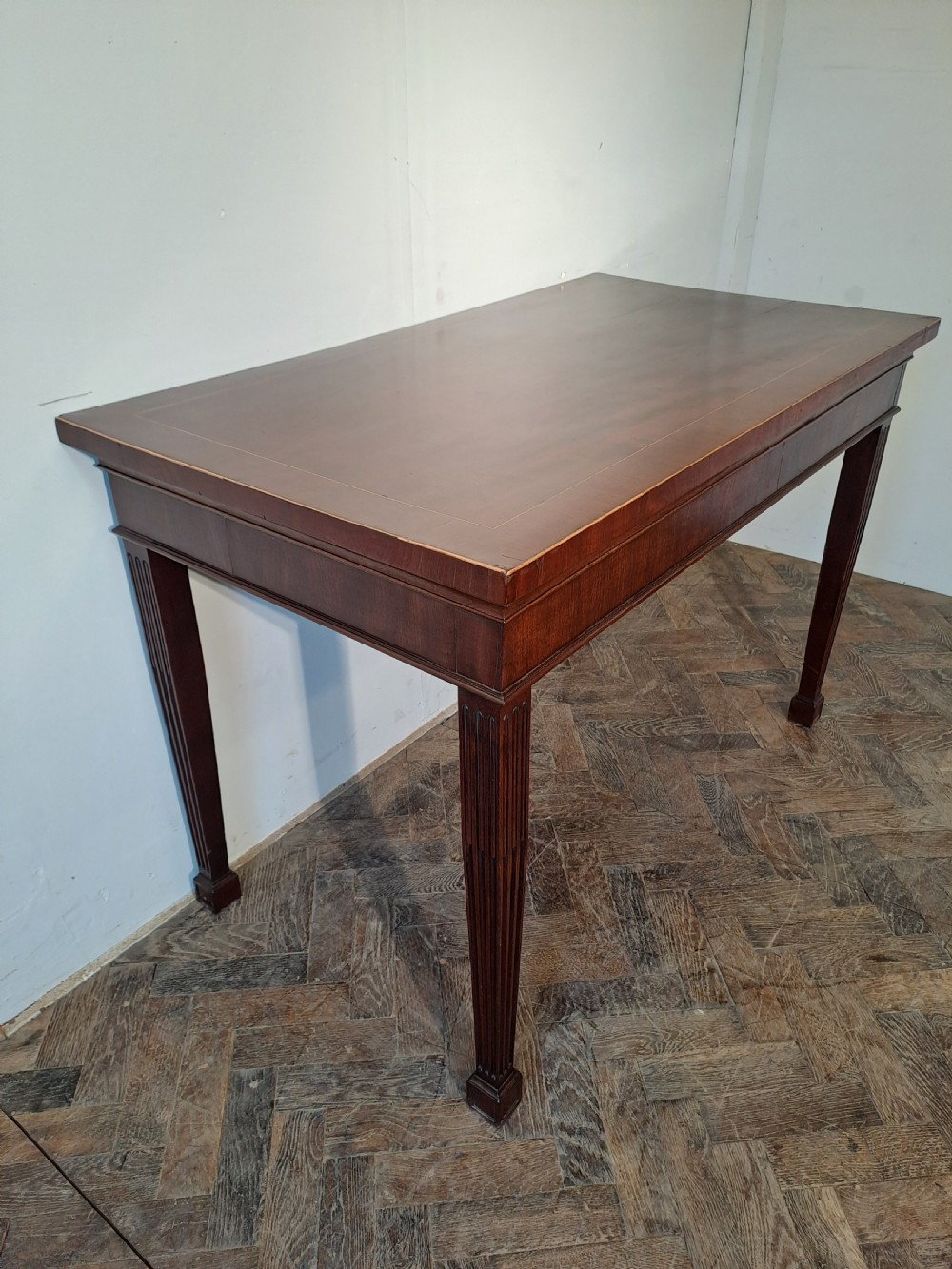 A Georgian dark mahogany rectangular console table featuring fluted square tapered legs and subtle top line inlay. View V