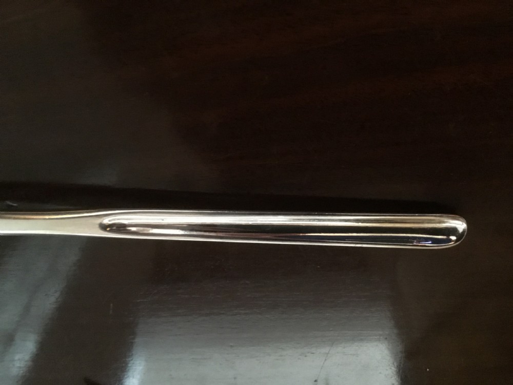 A Georgian double-ended sterling silver marrow scoop featuring a wide elongated trough at one end and a narrower trough stem at the other. View V