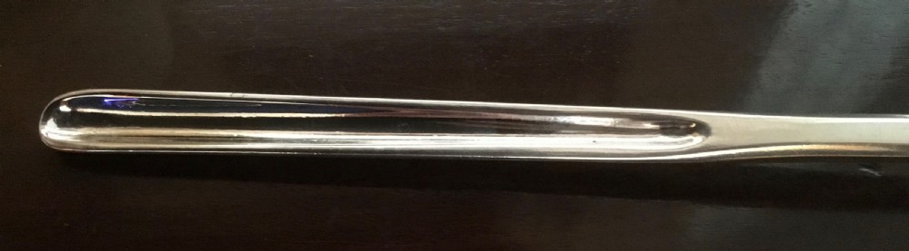 An antique Georgian double-ended sterling silver marrow scoop featuring two distinct sizes of elongated channel troughs. View II