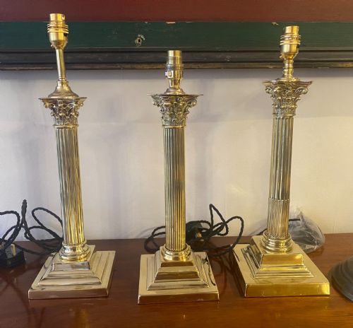 Three Edwardian Brass Corinthian Column Lamps