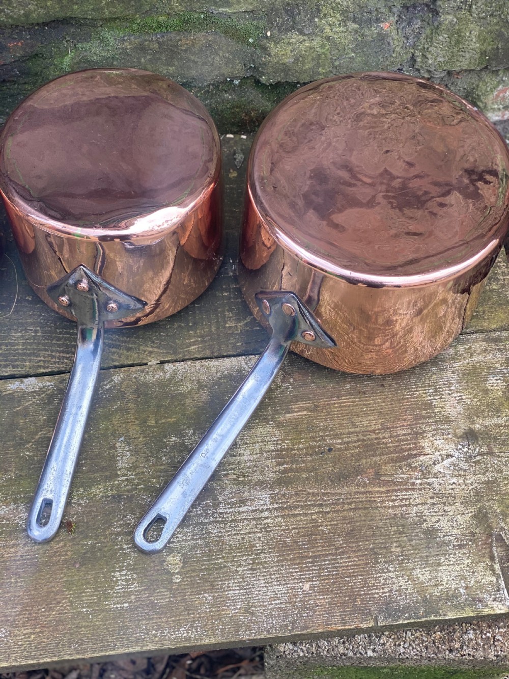 A harlequin set of 5 copper saucepans some with makers marks one for Harrods  View II