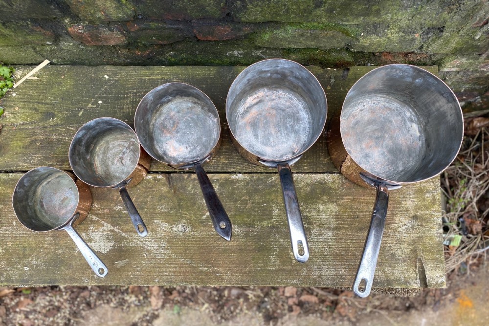 A harlequin set of 5 copper saucepans some with makers marks one for Harrods  View III