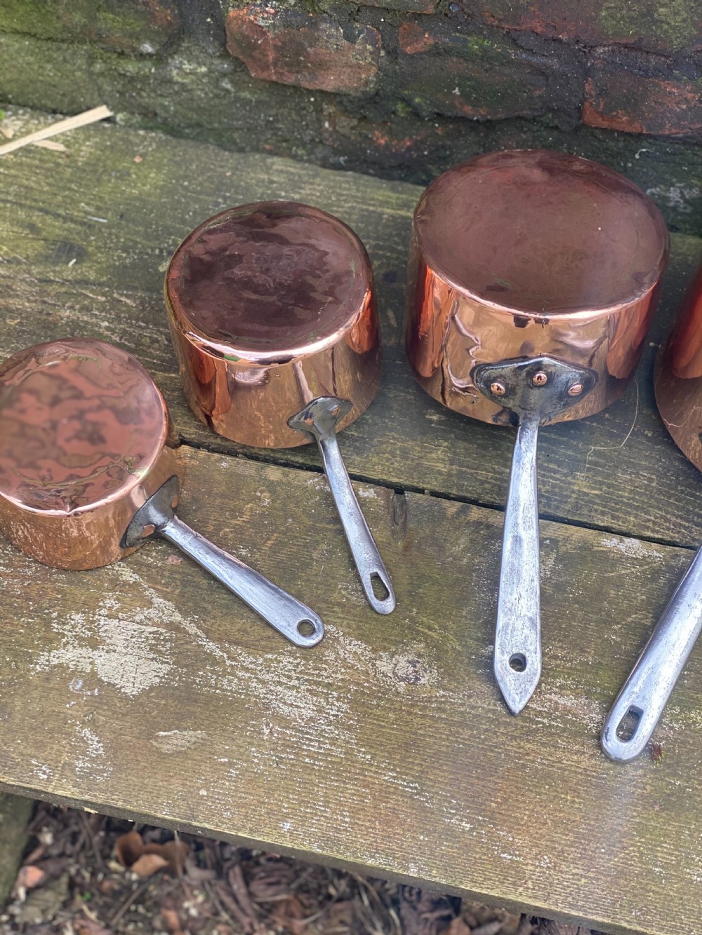 A harlequin set of 5 copper saucepans some with makers marks one for Harrods  View IV
