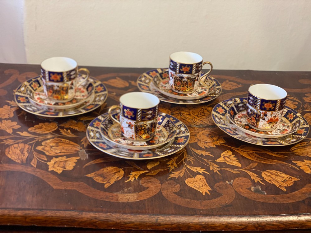 Set of four imari pattern derby style coffee cans and saucers 