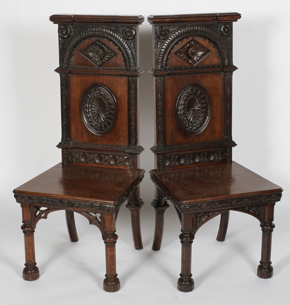 Two C19th carved oak gothic hall chairs 