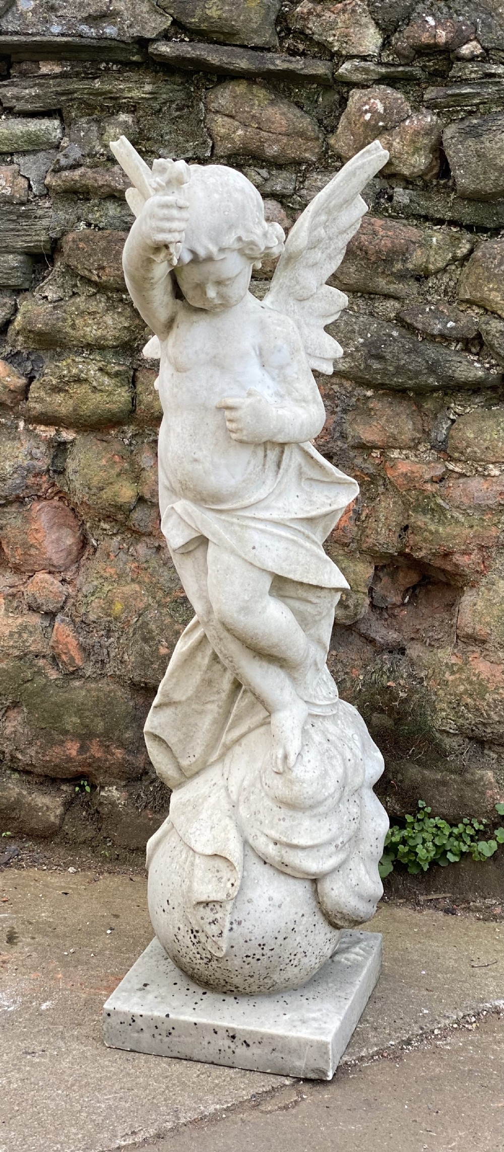Large marble carved cherub on a ball base 