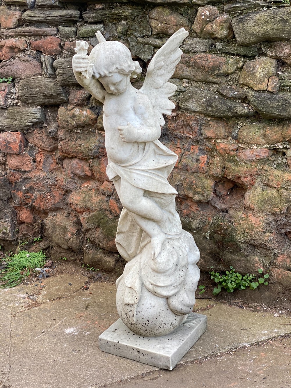 Large marble carved cherub on a ball base  View II