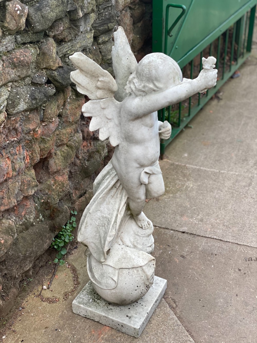 Large marble carved cherub on a ball base  View V