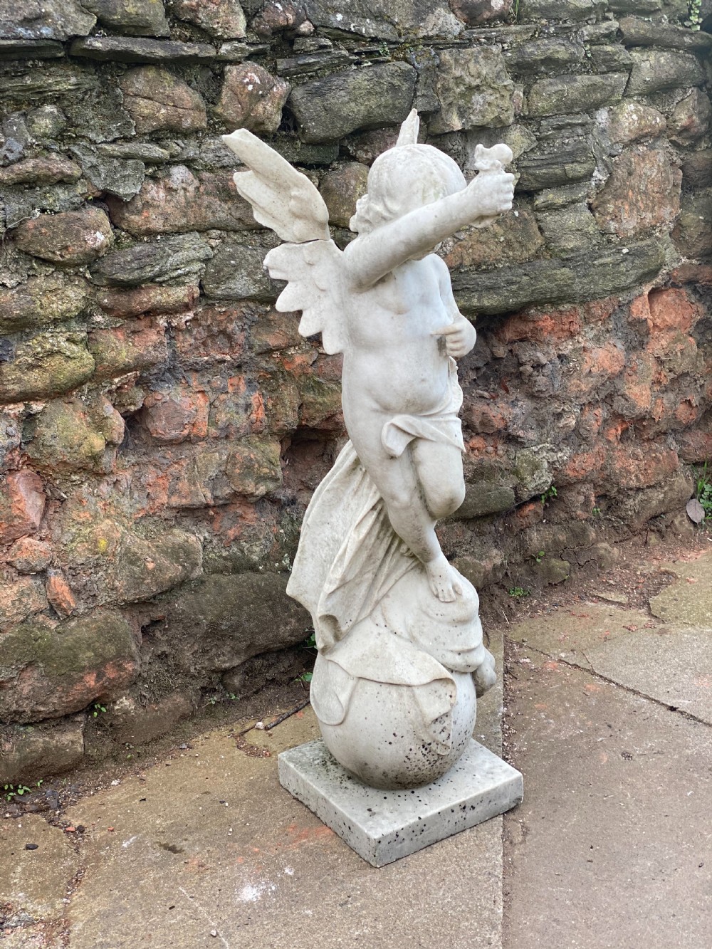 Large marble carved cherub on a ball base  View VI