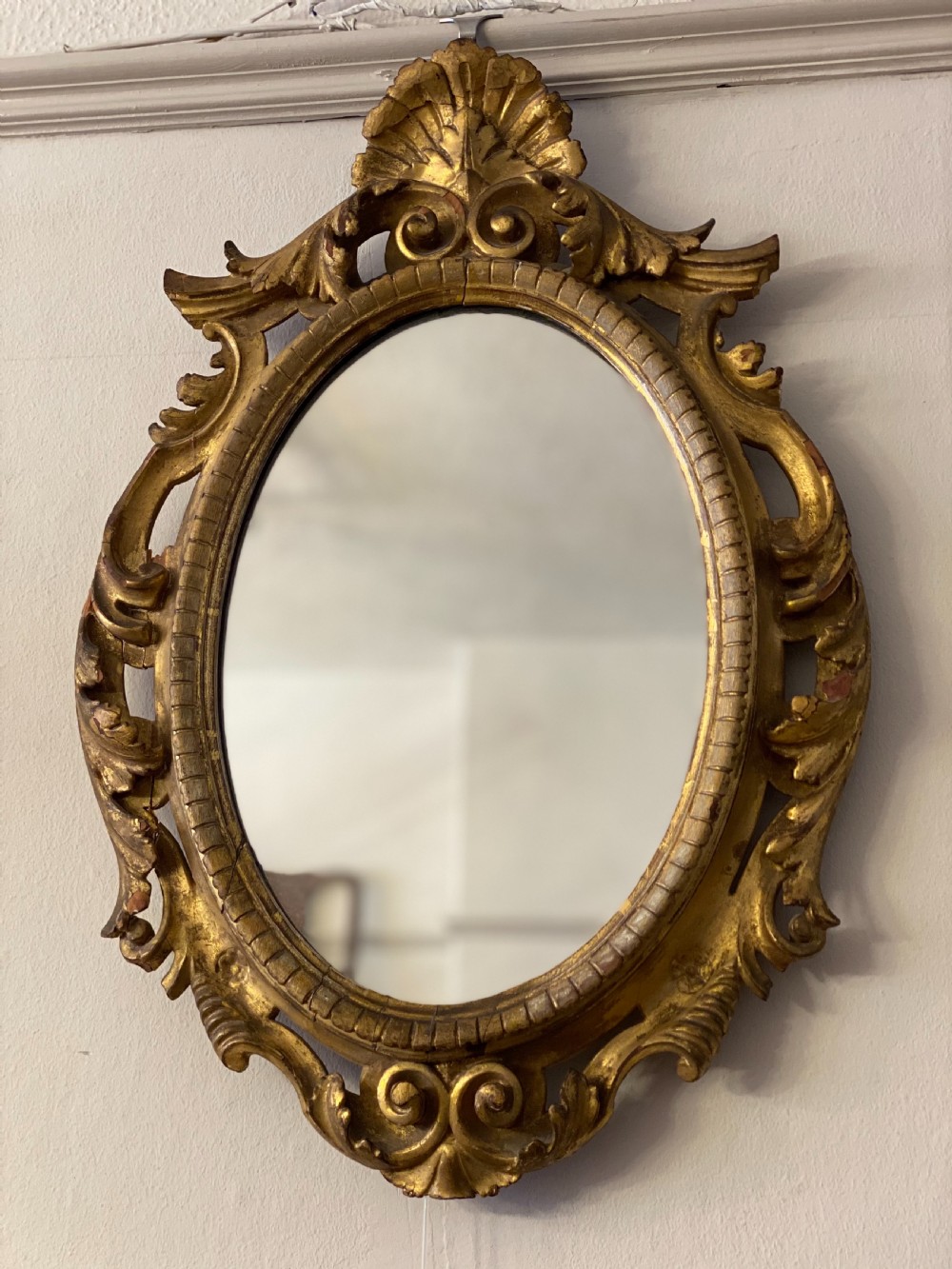 C18th giltwood oval carved mirror 