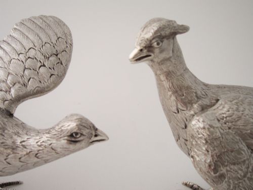 fig 1. A pair of detailed cast sterling silver pheasants portrayed in naturalistic poses against a light background.