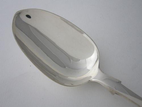fig 1. An antique Victorian sterling silver basting spoon featuring a fiddle pattern handle and polished oval bowl.