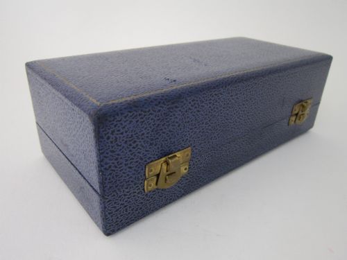 fig 1. A three-piece Elizabeth II sterling silver condiment set with textured bark-effect bodies, including a mustard pot, salt pot, pepper pot, and two small spoons, housed in a blue presentation case.