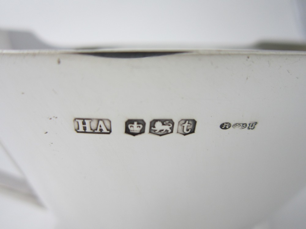 A polished sterling silver Art Deco sauce boat with clean geometric lines, an integrated pouring spout, a loop handle, and a raised oval foot. View V