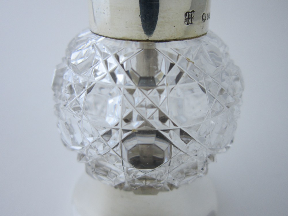 A Victorian sterling silver and cut glass pepper mill with a hand crank handle and hallmarked silver base. View III