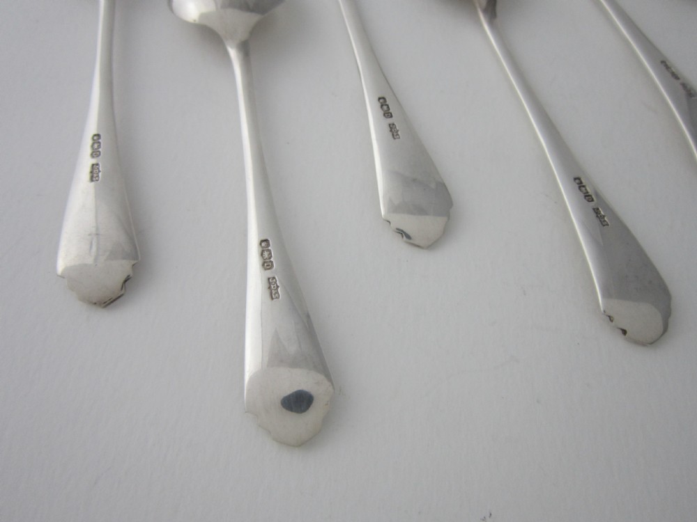 A set of six sterling silver grapefruit spoons with pointed bowls and stepped handles presented inside a fitted black velvet case. View VII