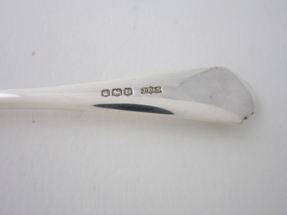 A set of six sterling silver grapefruit spoons with pointed bowls and stepped handles presented inside a fitted black velvet case. View VIII