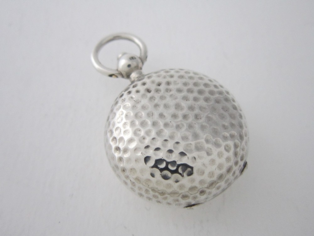 An Edwardian sterling silver sovereign case featuring a dimpled golf ball pattern and a top suspension ring. View III