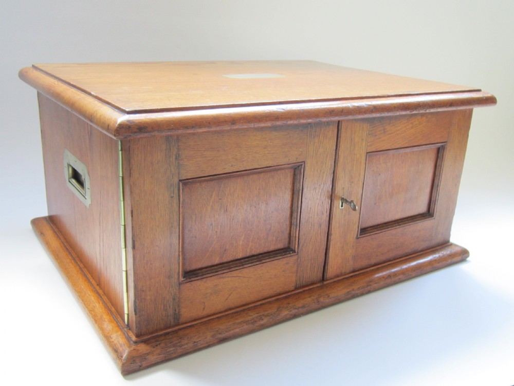 A Victorian fitted oak canteen chest with brass campaign handles open to reveal three drawers containing sterling silver fiddle pattern cutlery. View II