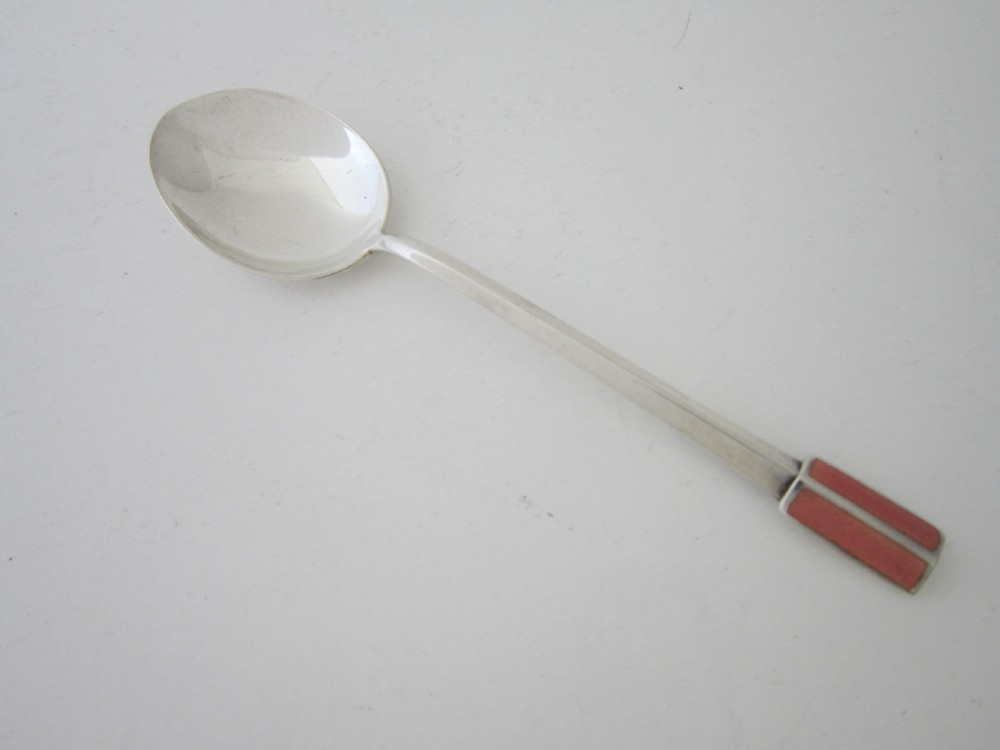 A set of six Art Deco sterling silver coffee spoons with pink enamel terminals presented in an open blue silk-lined case. View V