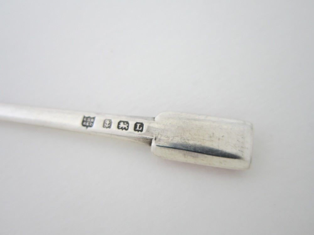 A set of six Art Deco sterling silver coffee spoons with pink enamel terminals presented in an open blue silk-lined case. View VIII
