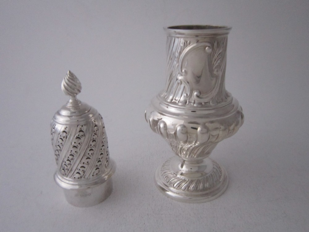 A Victorian sterling silver sugar caster with a spiralled finial, a hand-pierced cap, and a decorated baluster-shaped body. View III